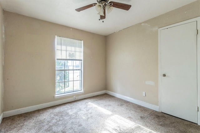 spare room featuring carpet floors and ceiling fan