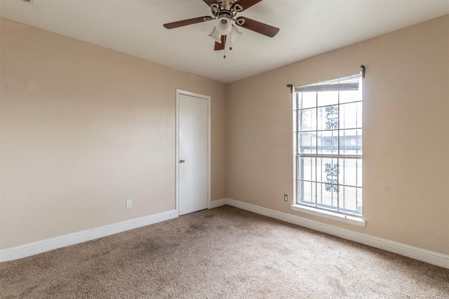 carpeted empty room featuring ceiling fan