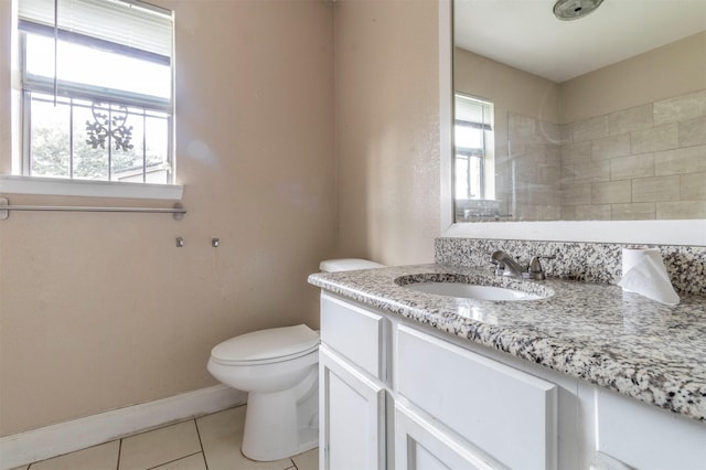 bathroom with tile patterned flooring, vanity, and toilet