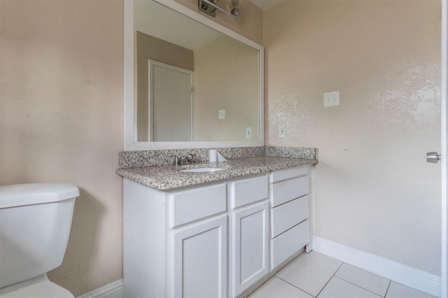 bathroom with tile patterned flooring, vanity, and toilet