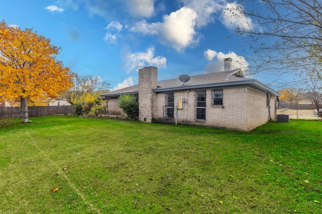 back of house with a lawn and cooling unit