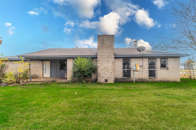 back of house with a lawn and a patio area