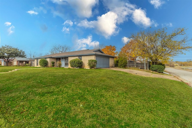 single story home with a front yard and a garage