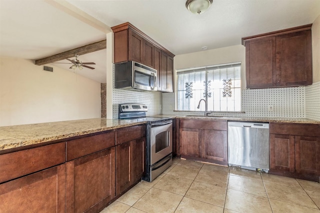 kitchen with backsplash, sink, beamed ceiling, and appliances with stainless steel finishes