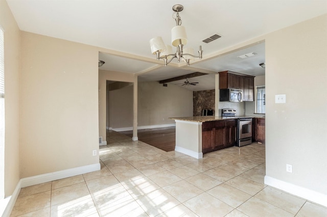 kitchen with ceiling fan with notable chandelier, light tile patterned flooring, stainless steel appliances, and tasteful backsplash