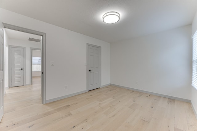 empty room with light hardwood / wood-style floors