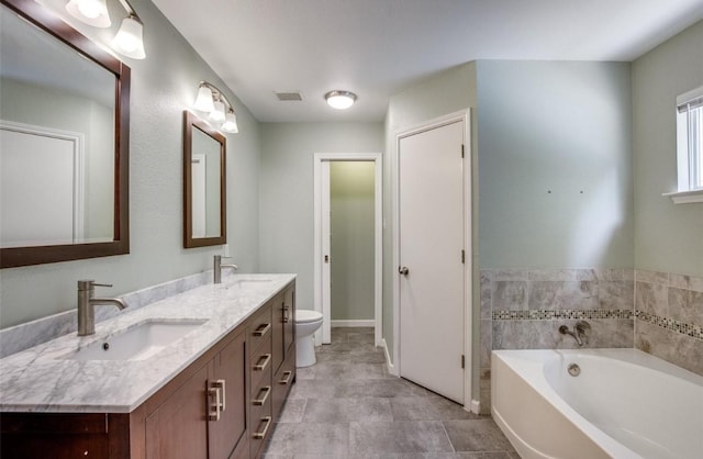 bathroom featuring vanity, toilet, and a bathtub