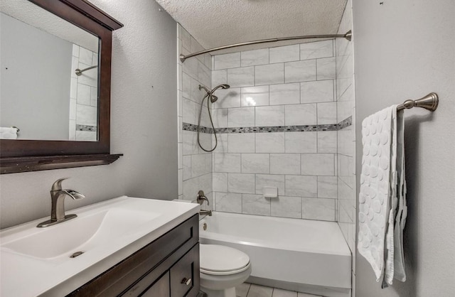 full bathroom with tile patterned floors, toilet, a textured ceiling, vanity, and tiled shower / bath combo