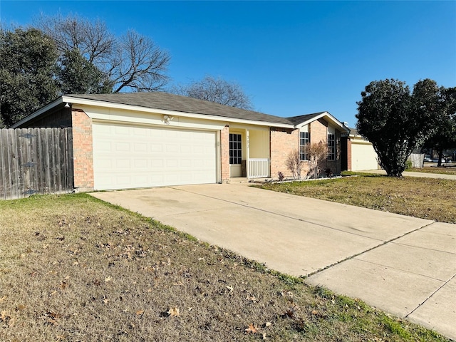 ranch-style home featuring a garage and a front lawn