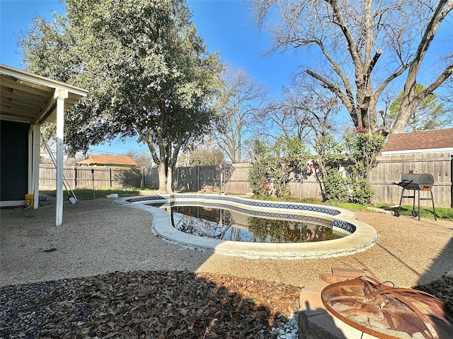 view of pool featuring a grill and a fire pit