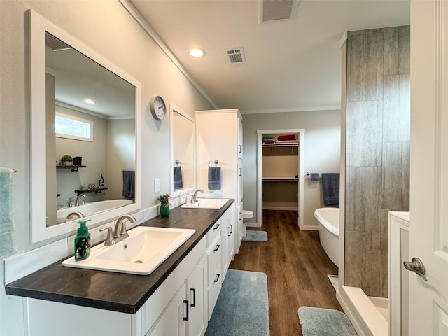 bathroom with vanity, separate shower and tub, wood-type flooring, and ornamental molding