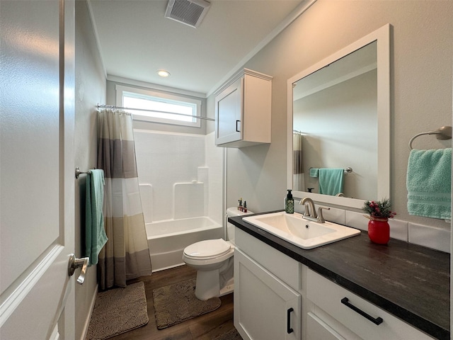 full bathroom with vanity, crown molding, toilet, wood-type flooring, and shower / tub combo