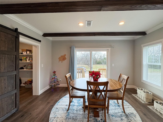 dining space with dark hardwood / wood-style floors, a barn door, a healthy amount of sunlight, and crown molding