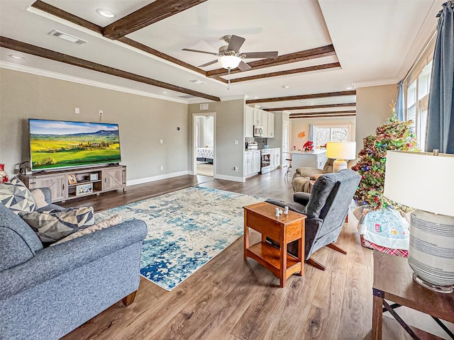 living room with ceiling fan, wood-type flooring, and ornamental molding