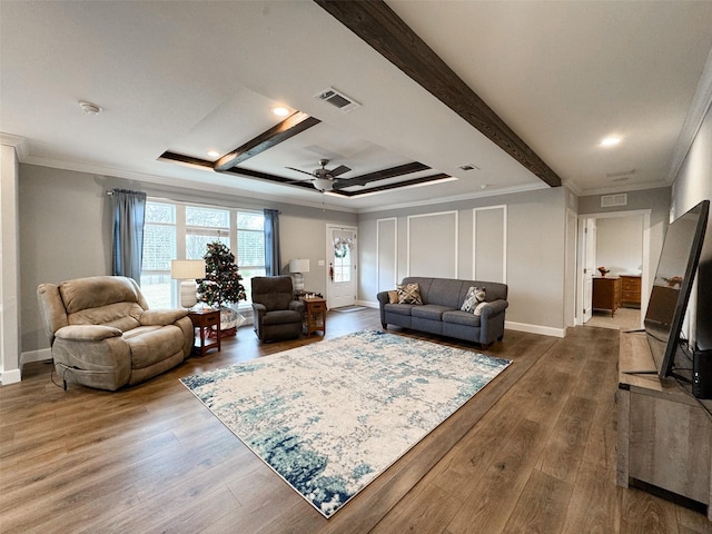 living room featuring beam ceiling, ceiling fan, hardwood / wood-style flooring, and ornamental molding