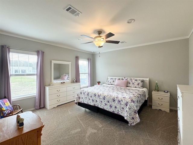 carpeted bedroom featuring ceiling fan and crown molding