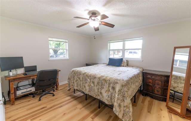 bedroom featuring light hardwood / wood-style floors, multiple windows, ornamental molding, and ceiling fan