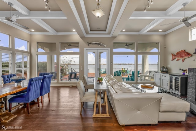 living room featuring coffered ceiling, plenty of natural light, dark wood-type flooring, and ceiling fan