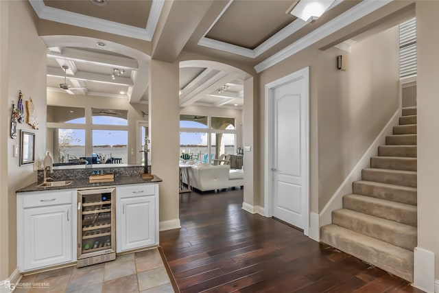 bar with wood-type flooring, white cabinetry, beverage cooler, and coffered ceiling