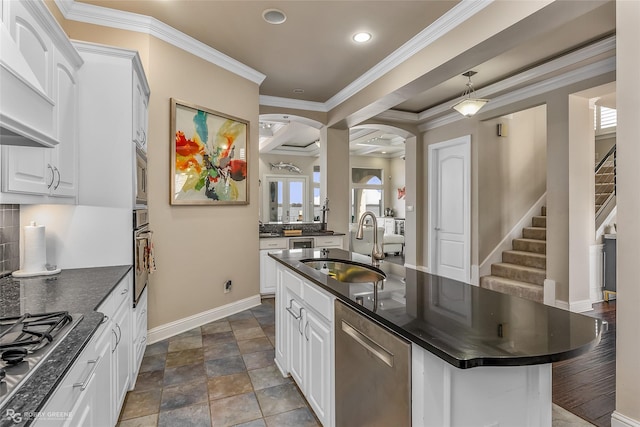 kitchen featuring sink, appliances with stainless steel finishes, custom range hood, white cabinets, and a kitchen island