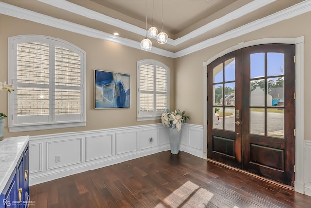 foyer entrance with crown molding, dark wood-type flooring, and french doors