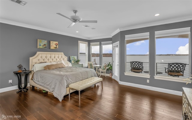 bedroom featuring dark wood-type flooring, a water view, crown molding, and access to exterior