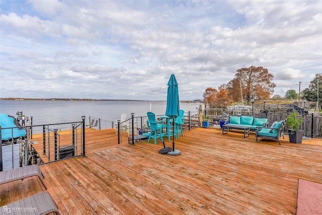 wooden deck with outdoor lounge area and a water view