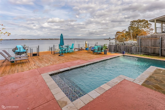 view of swimming pool featuring a deck with water view