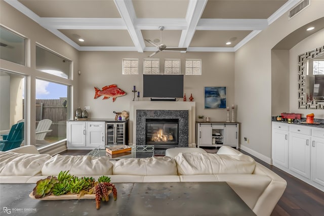 living room with dark hardwood / wood-style floors, a wealth of natural light, beverage cooler, and ceiling fan