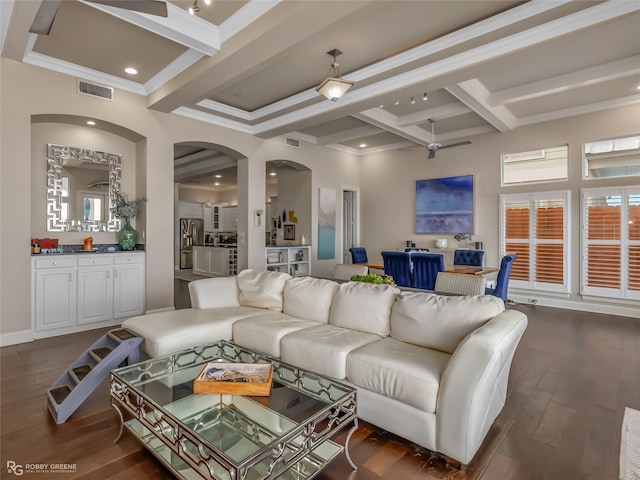 living room featuring beam ceiling, ceiling fan, dark wood-type flooring, coffered ceiling, and ornamental molding