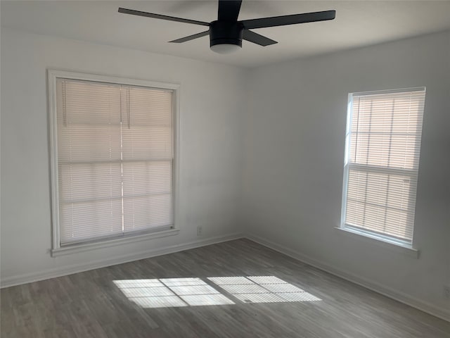 spare room featuring ceiling fan and dark hardwood / wood-style flooring