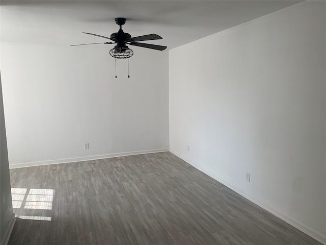 spare room featuring ceiling fan and dark hardwood / wood-style floors