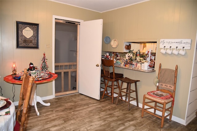 interior space featuring wood-type flooring and crown molding