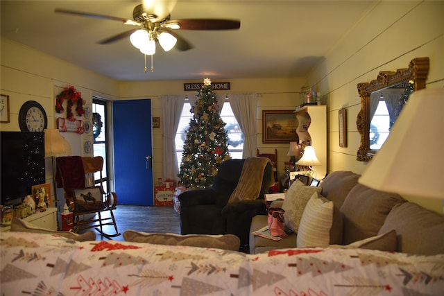 living room featuring ceiling fan and a healthy amount of sunlight