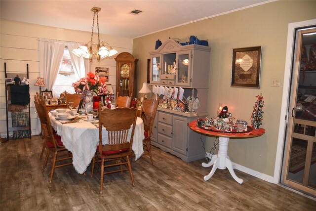 dining area featuring a chandelier and dark hardwood / wood-style floors