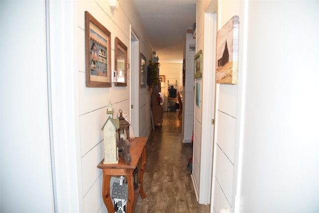 corridor with dark hardwood / wood-style flooring