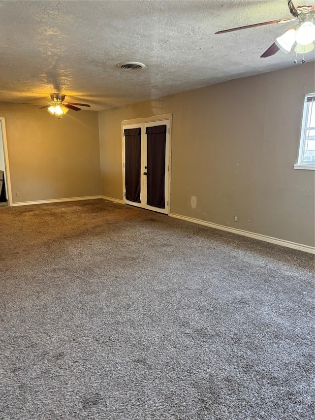 empty room featuring carpet floors and a textured ceiling