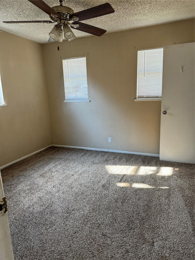 unfurnished room featuring carpet flooring, a textured ceiling, and ceiling fan