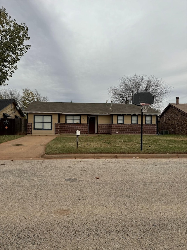 single story home featuring a front lawn and a garage