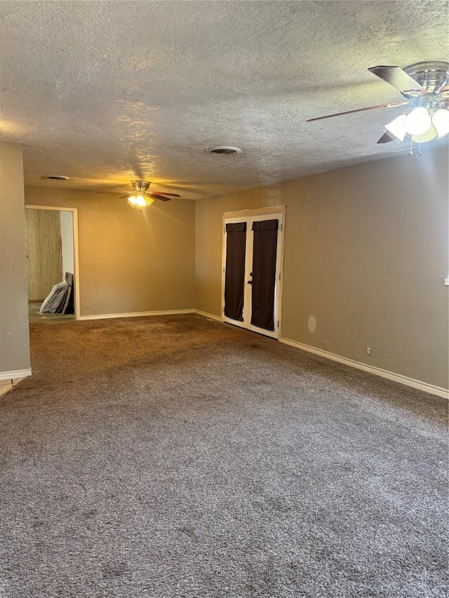 carpeted empty room with a textured ceiling