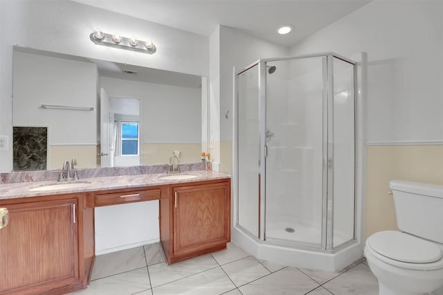 bathroom with vanity, toilet, and a shower with shower door