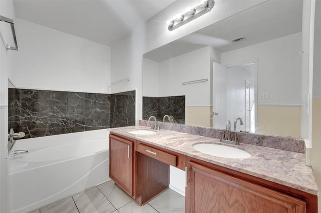 bathroom featuring a bath, vanity, and tile patterned floors