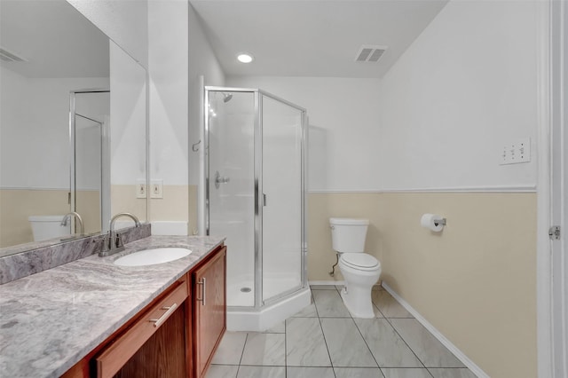 bathroom featuring an enclosed shower, vanity, and toilet