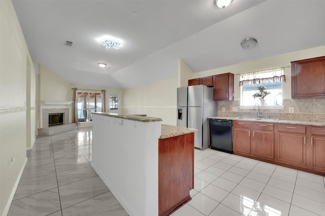 kitchen with sink, black dishwasher, stainless steel refrigerator with ice dispenser, backsplash, and lofted ceiling