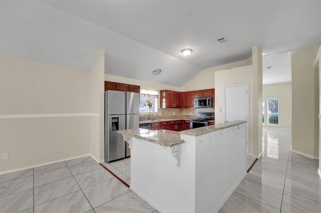 kitchen with tasteful backsplash, light stone counters, stainless steel appliances, sink, and lofted ceiling