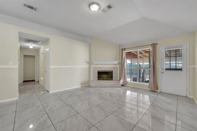 unfurnished living room with lofted ceiling and light tile patterned flooring