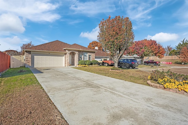 view of front of property with a front yard and a garage