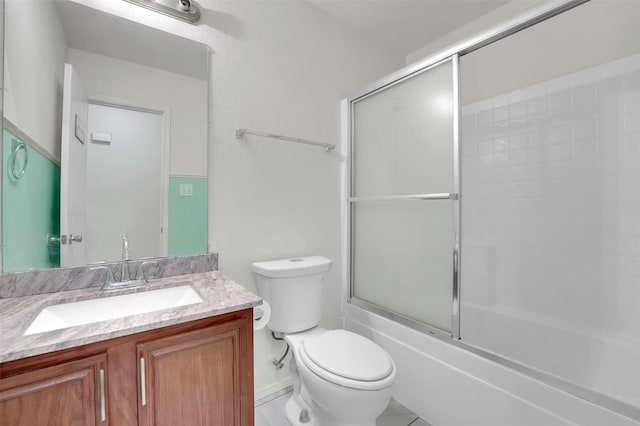 full bathroom featuring toilet, vanity, and combined bath / shower with glass door