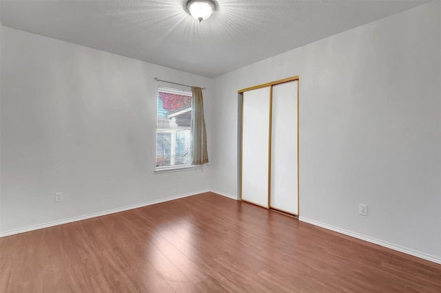 unfurnished room featuring dark wood-type flooring