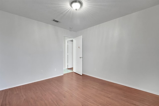 empty room with wood-type flooring